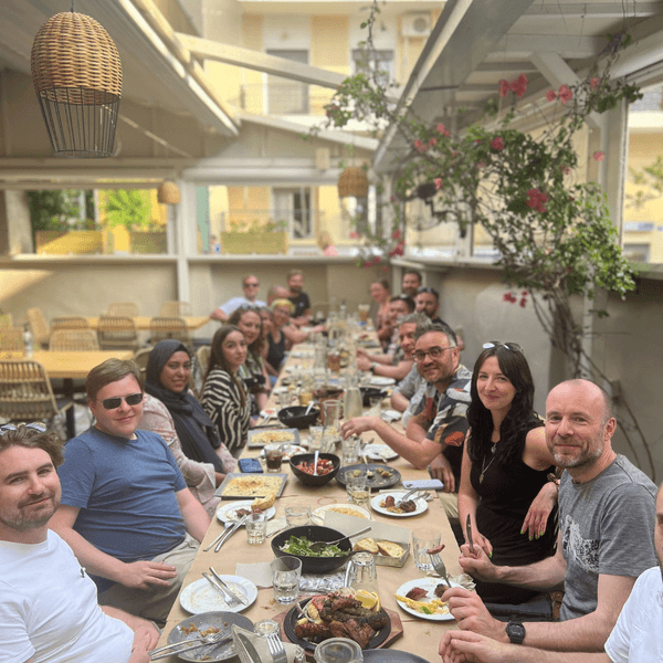 The Human Made team posing for a photo at dinner in an Athens restaurant